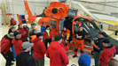 People Gathered Around a Helicopter