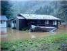 Home and Boat Impacted by Flooding