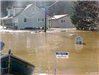 Homes and Signs Under Water Impacted by Flooding